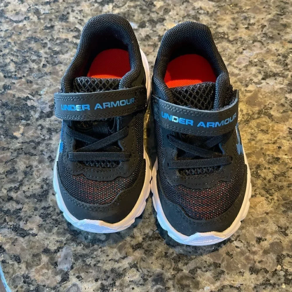 Baby under armour tennis shoes. Never worn. Size 5K. Black and blue